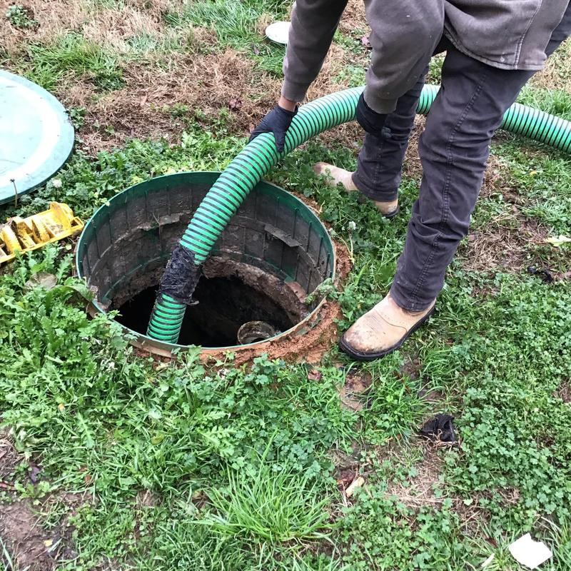 Septic tank with green hose pumping service