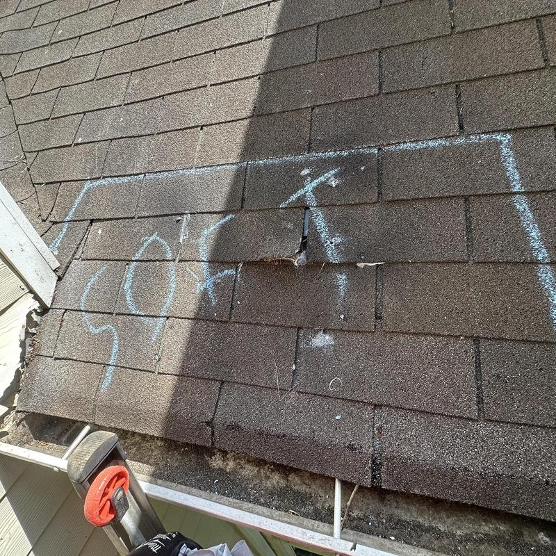 Roof shingles damage marked with chalk on residential roof