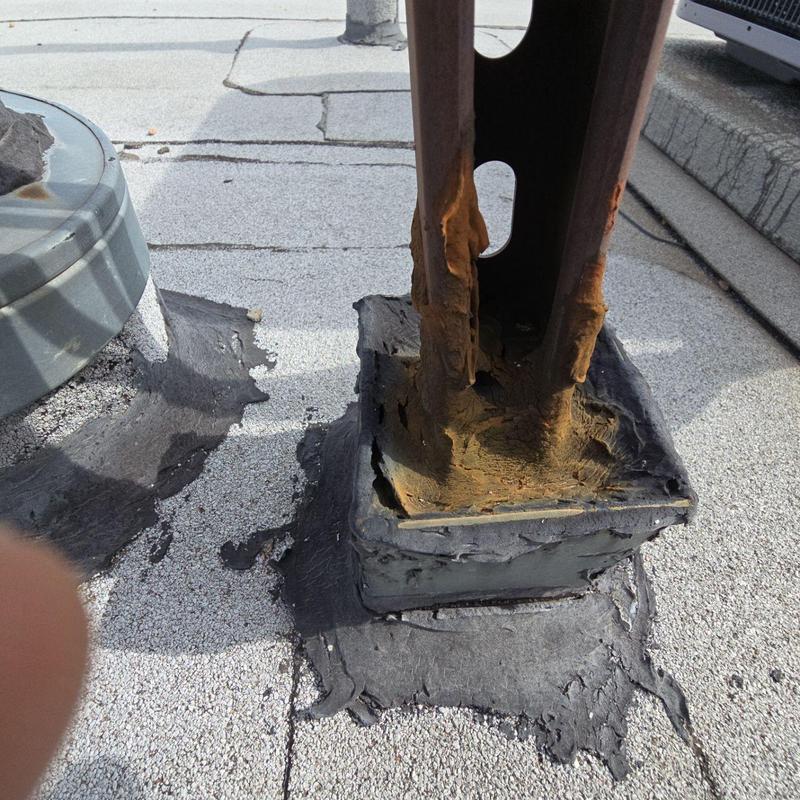 Pipe jack flashing on flat roof with rust damage Pipe jack flashing on flat roof with rust damage
