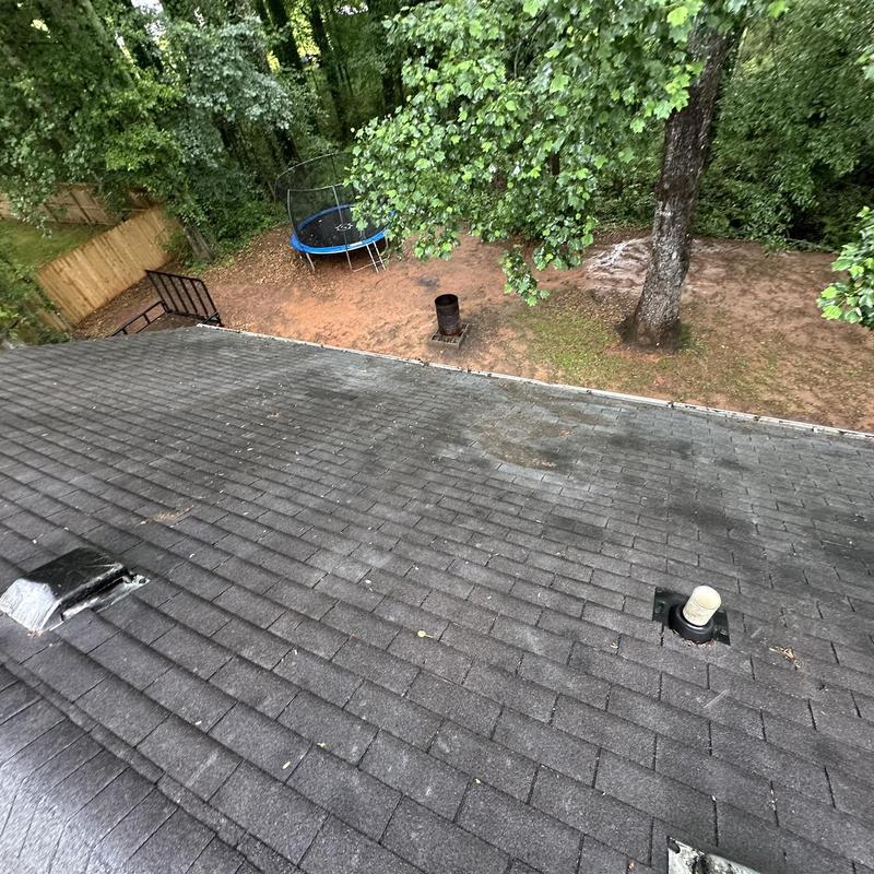Box vent and roof decking with tree and trampoline view
