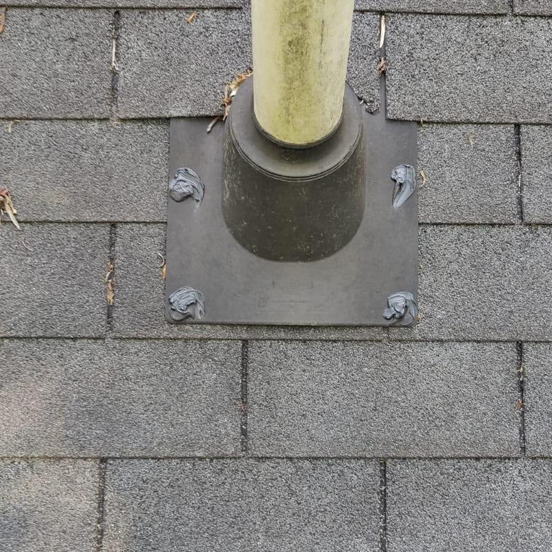 Box vent flashing on shingled roof with fresh caulk