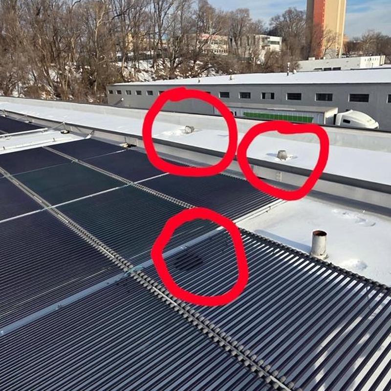 Roof drain pipes blocked by ice on warehouse roof