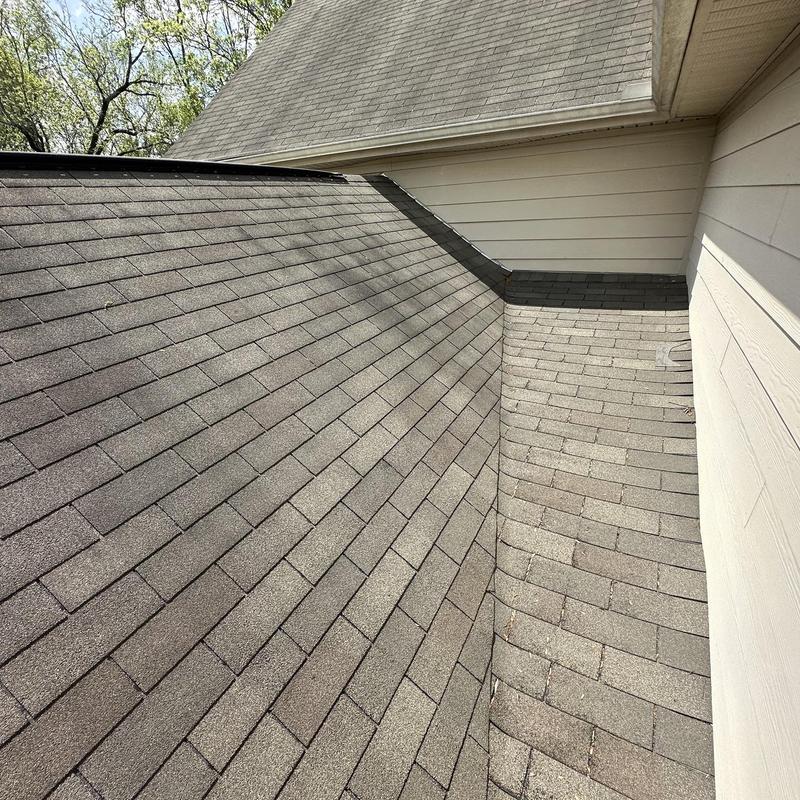 Asphalt shingle roof showing color variation and replacement issues