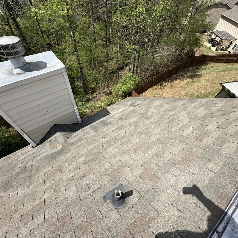 Asphalt roof shingles with chimney and vent pipe