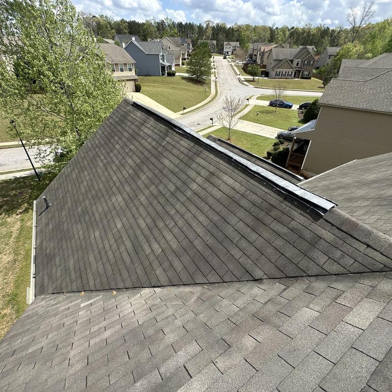 Asphalt shingle roof with damaged ridge vent in Loganville, GA