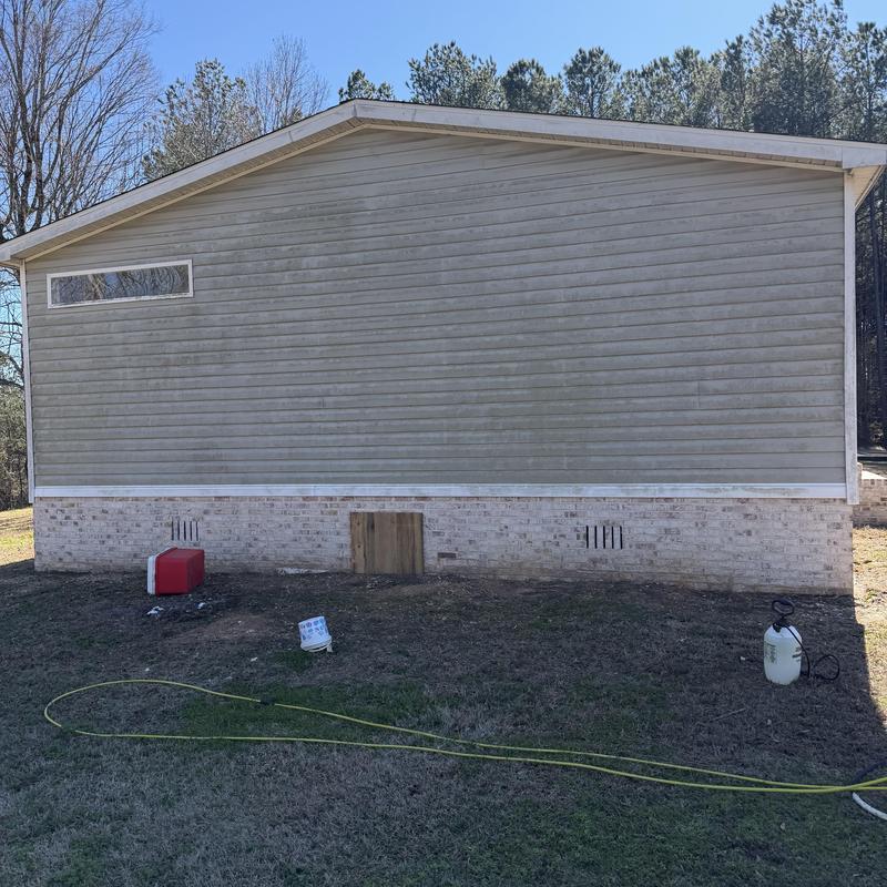 Vinyl siding pressure washing on residential home exterior Vinyl siding pressure washing on residential home exterior