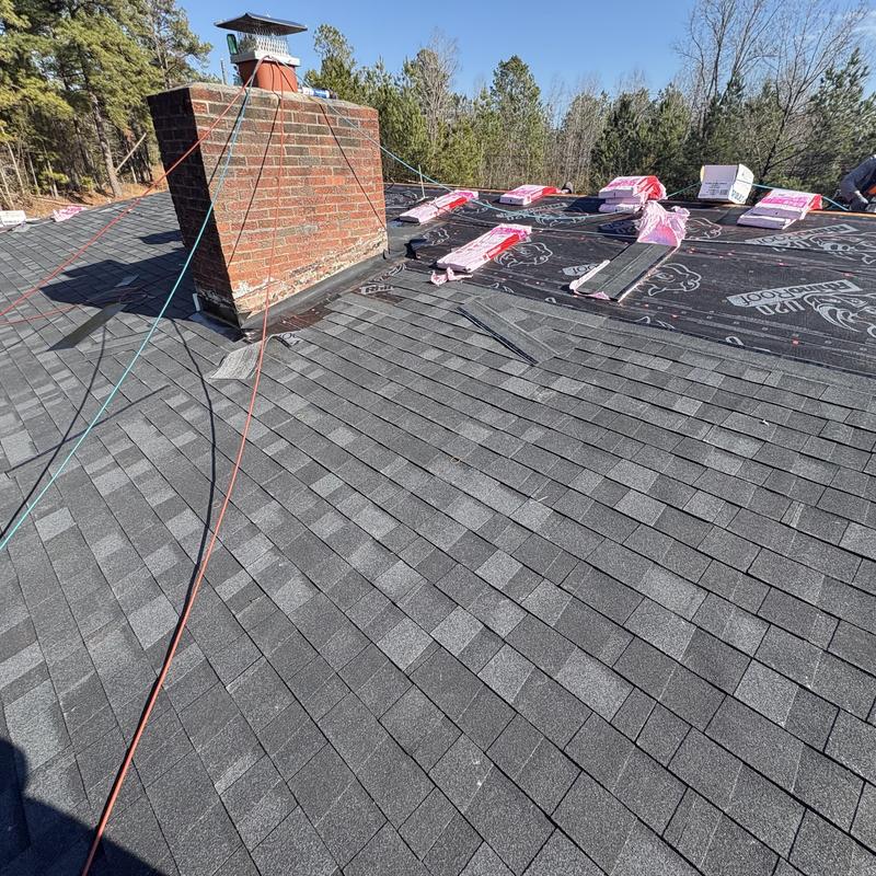 Roof shingles installation around brick chimney