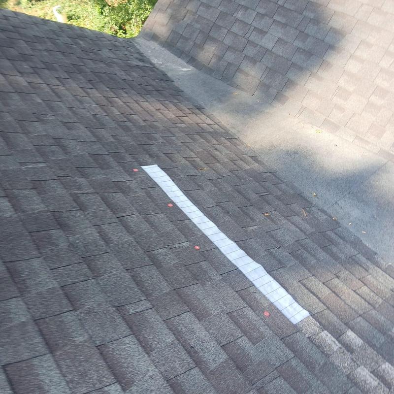 Roof shingles with strip patch on damaged area