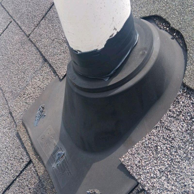 Roof vent pipe flashing with caulk and shingles
