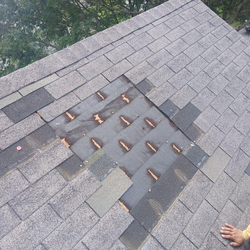Asphalt shingles with missing section on roof