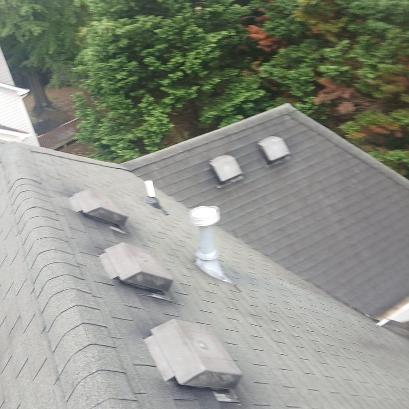 Roof plumbing vent pipe with flashing on shingle roof