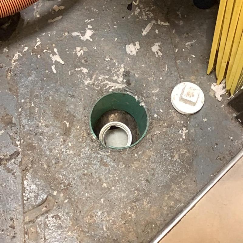 Drain line with open cleanout on concrete floor