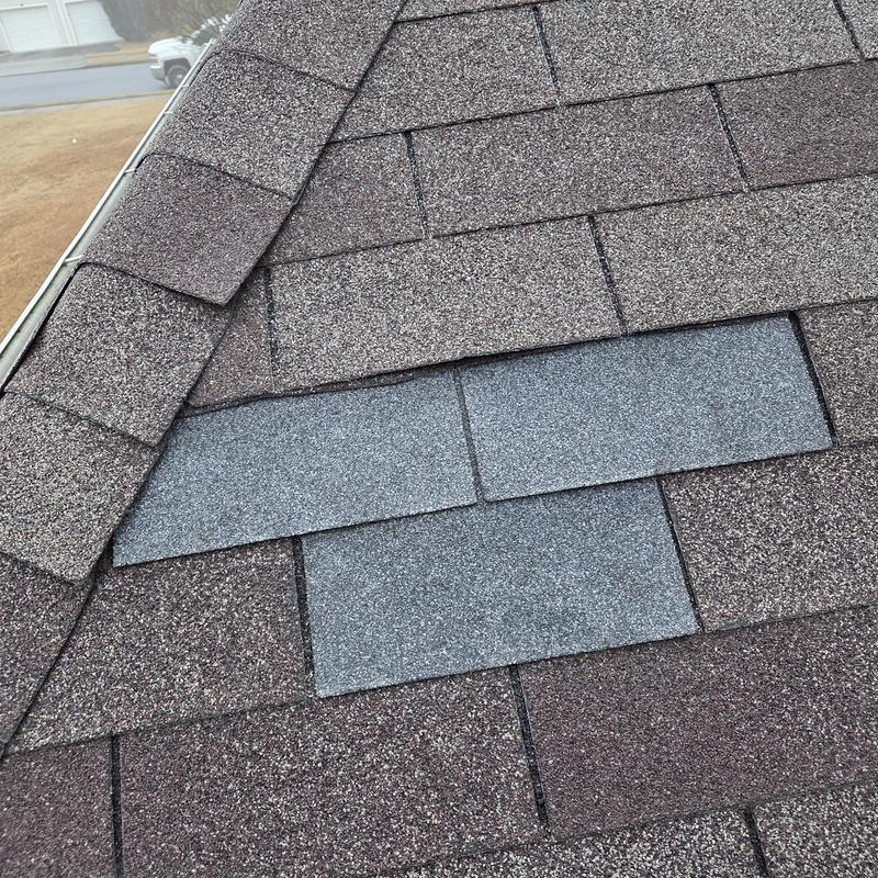 Roof shingles with replaced damaged sections and pipe boot