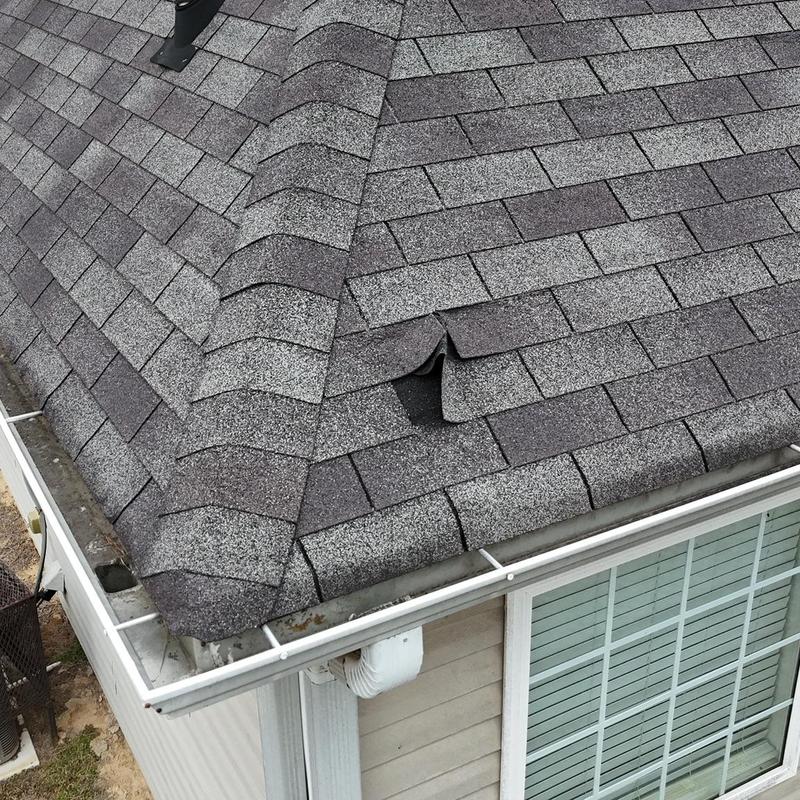 Shingles with damage near pipe boot on asphalt roof