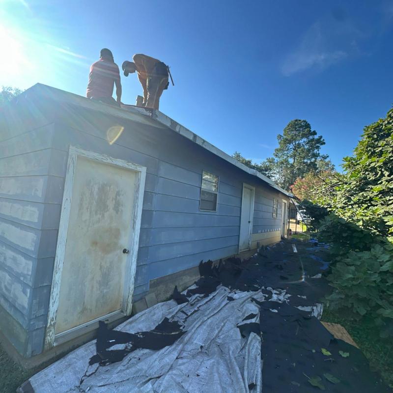 Roof shingles removal with workers inspecting on roof Roof shingles removal with workers inspecting on roof
