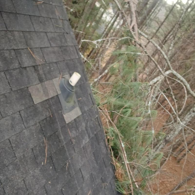 Roof shingles and vent pipe flashing with debris removal