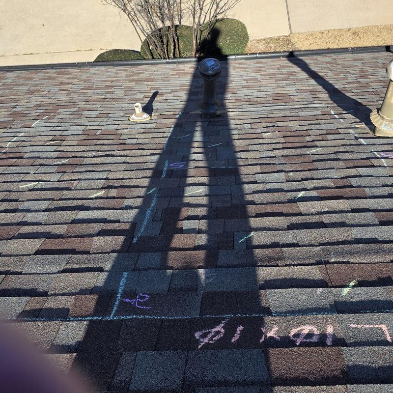 Asphalt shingle roof with chalk markings for hail damage