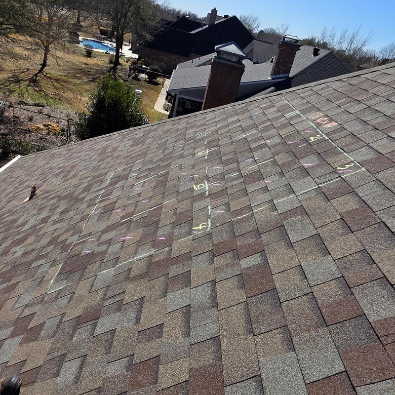 Asphalt shingle roof with hail damage markings