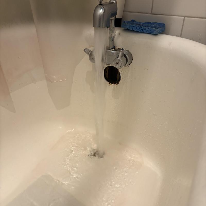 Bathtub drain with flowing water after clog removal