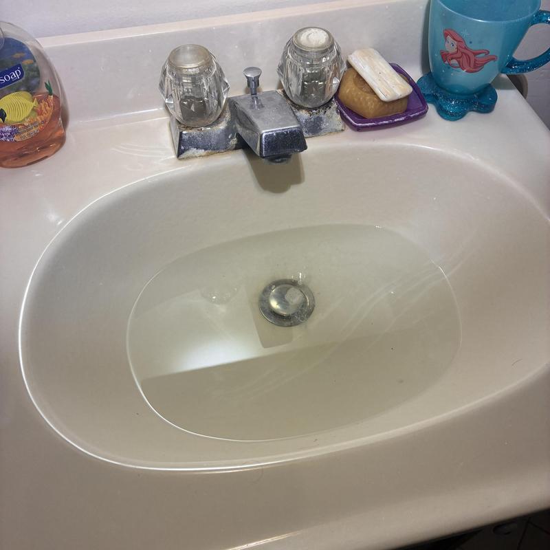 Basin sink with faucet and soap dishes on countertop