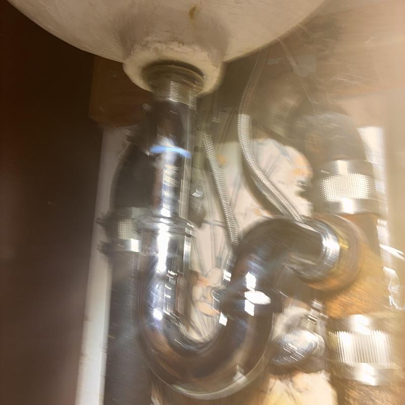 Basin sink P-trap and drain pipes under sink