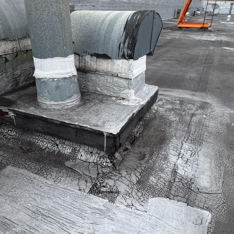 Flat roof membrane with vent pipe flashing and damage