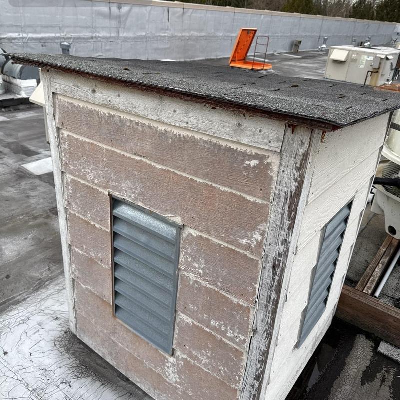 Roof vent with weathered siding on flat roof