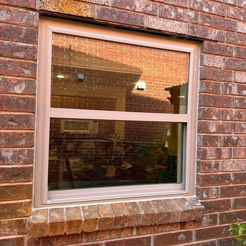 Tan vinyl Burris window with Low-E glass installed