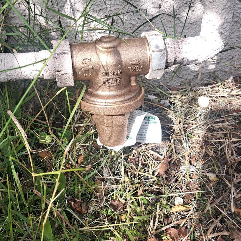 Pressure regulator on front water main outdoors