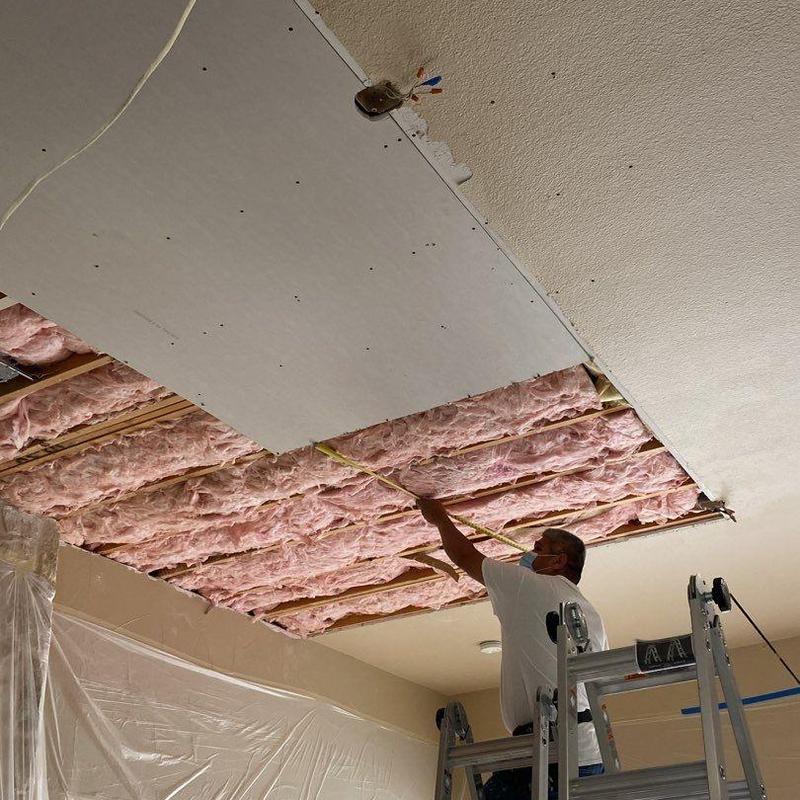 Ceiling insulation and drywall installation in progress