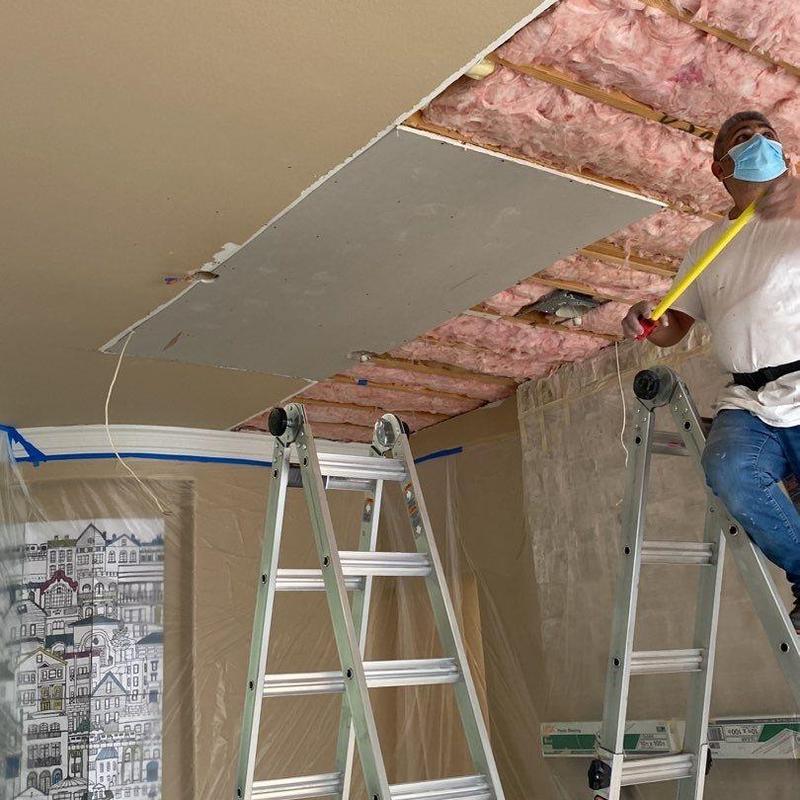 Ceiling drywall and insulation installation with ladders