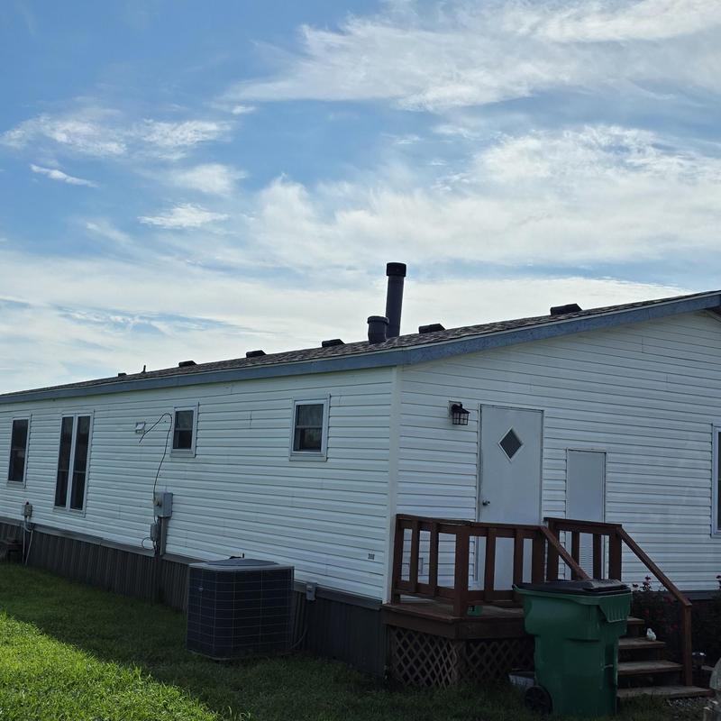 Manufactured home roof with wind and hail damage