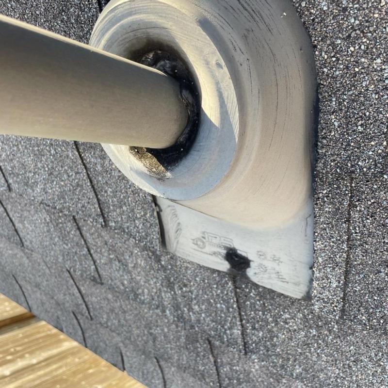 Pipe boot flashing with seal deterioration on roof shingles