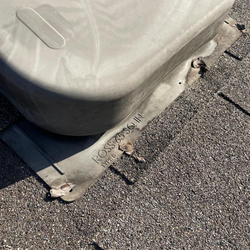 Roof vent flashing with rusted fasteners on asphalt shingles