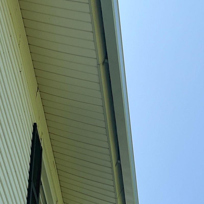 Roof soffit and fascia inspection under clear sky