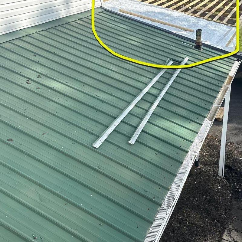 Metal roof with hail damage and ventilation pipe