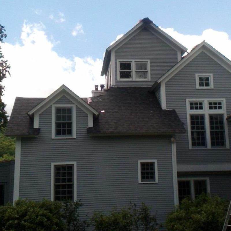 Asphalt shingle roof on multi-story gray house
