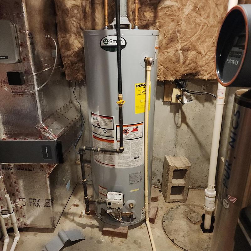 Gas water heater installation with piping in basement