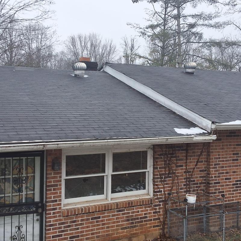 Asphalt shingle roof with ridge vent and ventilation turbines