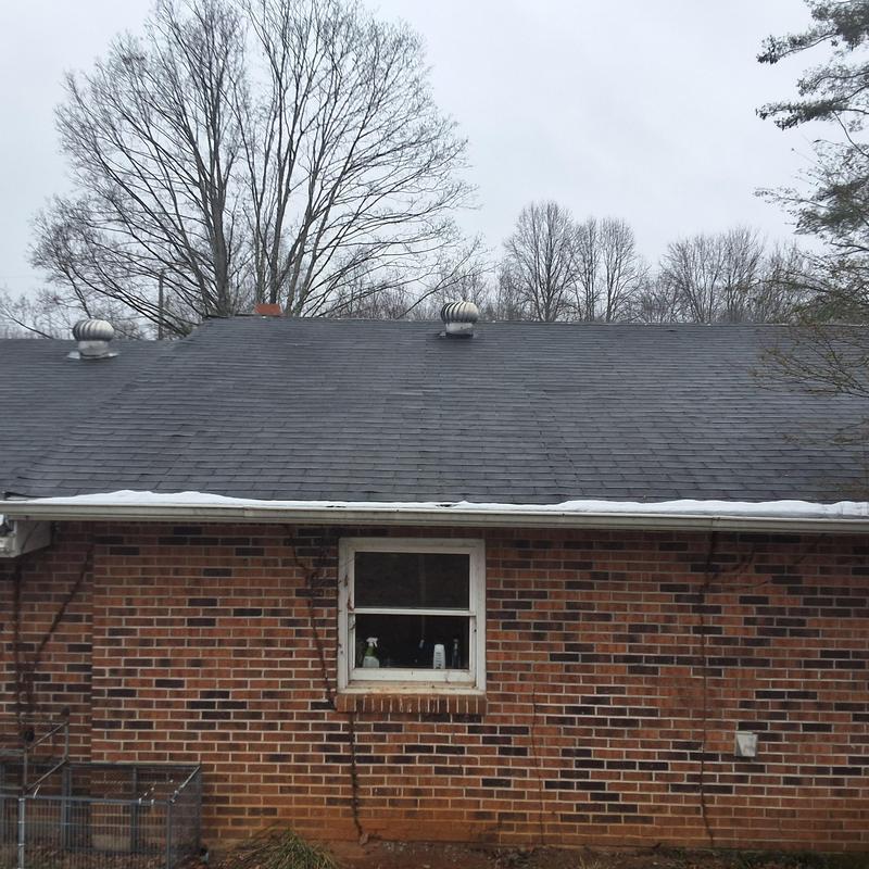 Asphalt shingle roof with turbine vents on brick house