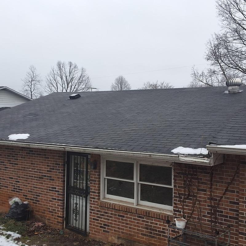 Asphalt shingle roof with light snow patches in Piney Flats