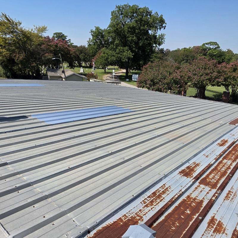 Metal roofing with hail damage and rust patches