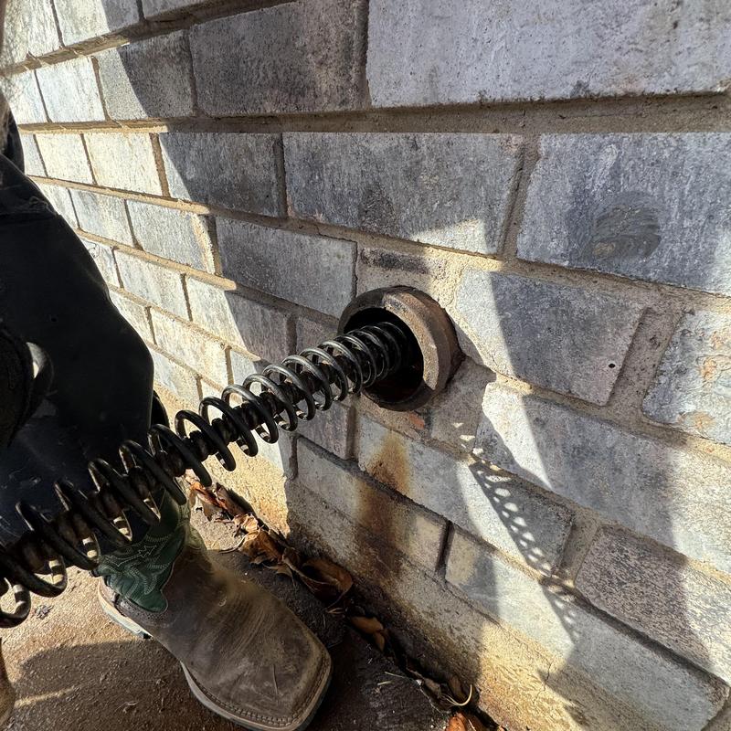 Cast iron kitchen drain pipe with cleaning auger
