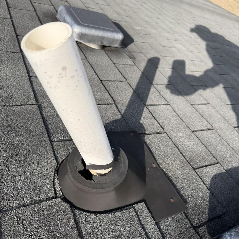 Pipe boot with damaged seal on shingle roof
