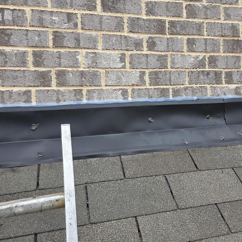Wall flashing installation on brick wall and shingle roof