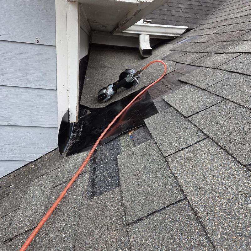 Dead valley roof flashing with pneumatic tool on shingles