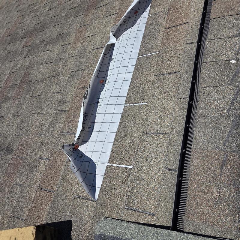 Roof shingles and underlayment exposed on roof repair