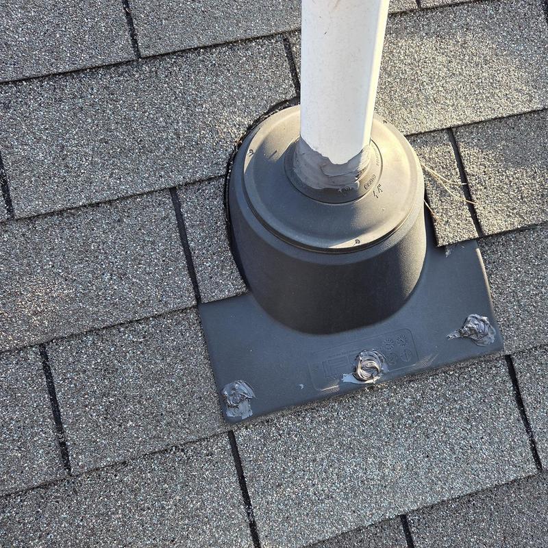 Roof pipe flashing with caulked seals on shingles