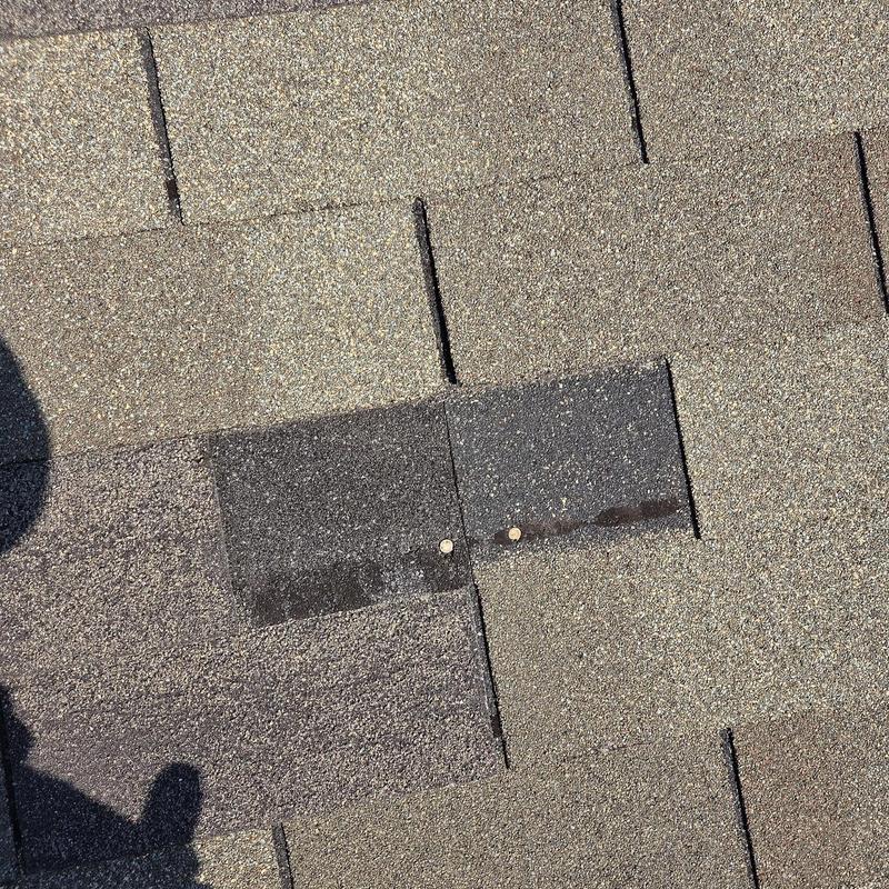 Asphalt roof shingles with two new nails installed