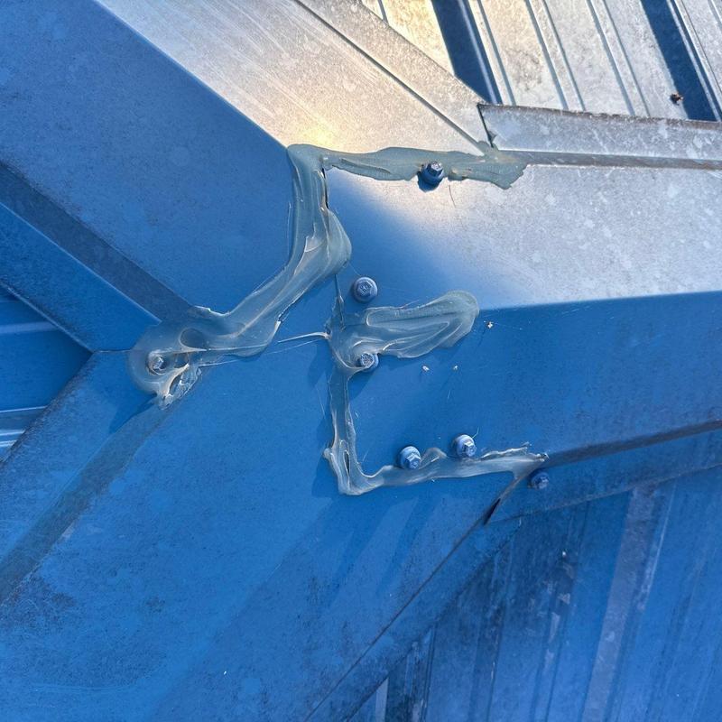 Metal roof flashing with sealant and fasteners